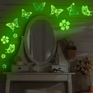 Luminous green butterfly wall stickers glowing on a dark wall for home decoration
