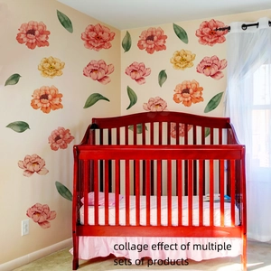 Watercolor peony wall decals in pink and orange tones decorating a nursery room wall
