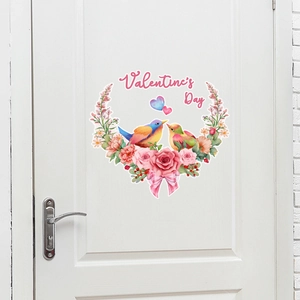 Close-up of Valentine's Day wall sticker with birds and roses on a white wooden door