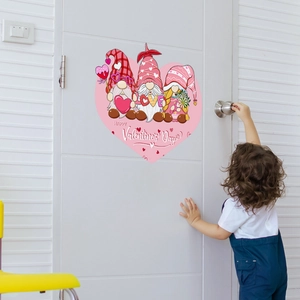 Close-up of Valentine's Day pink gnome heart wall sticker applied on a white room door