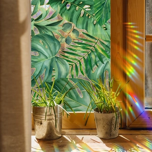 Tropical green palm leaves window film with gold edges and colorful light refraction