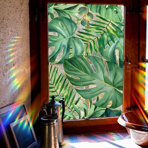 Tropical palm leaf window film with gold glitter edges and rainbow light effect