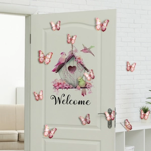 Close-up of pink 3D butterfly wall stickers and a floral Welcome birdhouse door decal
