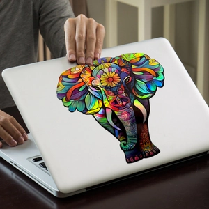 Holographic elephant decal with mandala patterns on a white laptop cover, iridescent finish