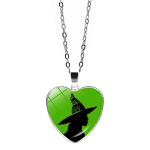 Wicked heart shaped witch silhouette pendant necklace with green background and silver chain