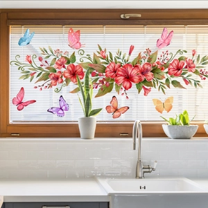 Double-sided floral vine and butterfly window stickers on a bright kitchen glass background