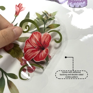Close-up of double-sided floral vine window sticker with adhesive backing being peeled
