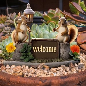 Close-up of squirrel garden stake with welcome sign and lamp in a succulent pot