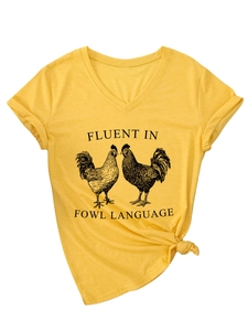 Close-up of a mustard yellow V-neck tee with a rooster print and rolled sleeve detail