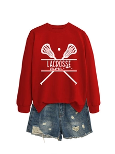Detail of red Lacrosse Mom sweatshirt with white crossed sticks graphic and frayed denim shorts