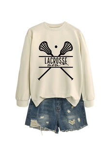 Detailed view of cream sweatshirt with Lacrosse Mom print and denim shorts set