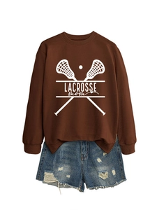 Brown Lacrosse Mom sweatshirt paired with distressed denim shorts for casual style