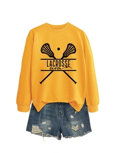 Detail of Lacrosse Mom yellow sweatshirt with distressed denim shorts and frayed hems