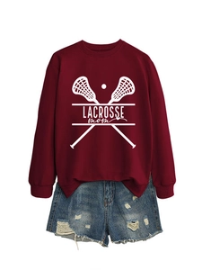 Detail of ribbed cuffs on burgundy Lacrosse Mom sweatshirt and distressed denim shorts