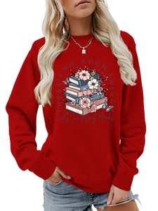 Macro detail of the floral book art and typography on a red long sleeve sweatshirt
