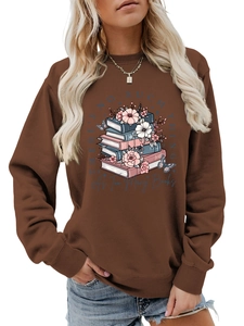 Detail of crewneck sweatshirt showing a floral book graphic and blue butterfly print