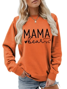 Detail of orange crewneck sweatshirt with MAMA BEAR print and soft cotton texture