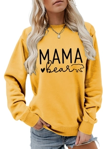 Close-up of the Mama Bear letter print and ribbed cuffs on a mustard yellow sweatshirt