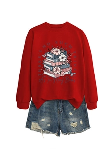 Detail of red crewneck sweatshirt featuring a floral book print and frayed denim shorts