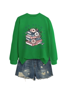 Detail view of the floral book print on the green sweatshirt with denim shorts set