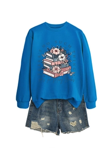 Detail of royal blue sweatshirt featuring a stacked books and pink floral graphic print