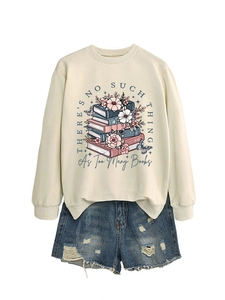Close-up of crewneck sweatshirt with books and floral print and distressed denim shorts