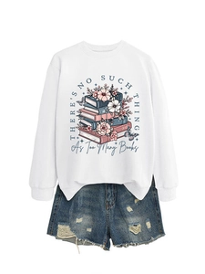 Flat lay of a white sweatshirt with floral book print and frayed denim shorts