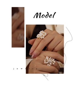 Close-up of gold plated irregular rings with white pearls and sparkling zircon on finger