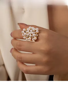 Detail of luxury gold adjustable ring with cluster of white pearls and sparkling cubic zirconia
