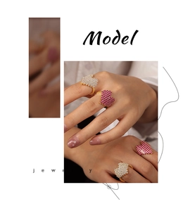 Close-up of luxury gold-plated rings with heart-shaped pink and white zircon stones
