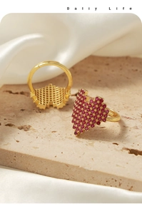 Detail of pixel heart rings with red cubic zirconia and hollow grid structure