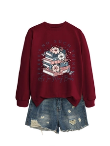 Burgundy sweatshirt with book illustration paired with ripped blue denim shorts