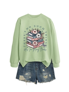 Flat lay of light green crew neck sweatshirt with floral book print and denim shorts