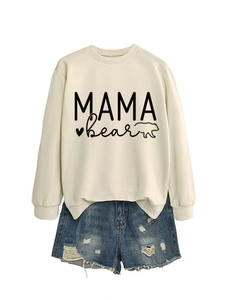 Detail of cream Mama Bear sweatshirt paired with distressed blue denim shorts