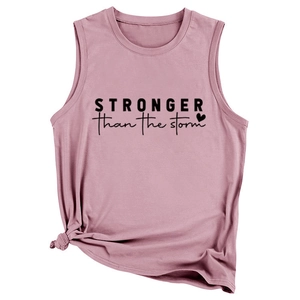 Detail of dusty pink tank top featuring STRONGER than the storm slogan and knotted hem