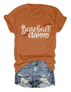 Flat lay of a burnt orange Baseball Grammy short sleeve tee with distressed denim shorts