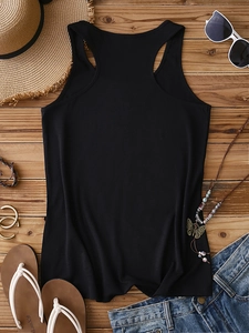 Flat lay of black racerback tank top styled with summer beach accessories and denim shorts