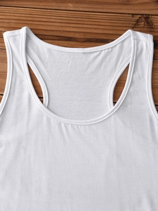 Detail of white cotton tank top neckline and stitching on a brown wooden background