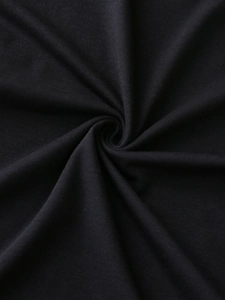 Close-up of black high-density knit fabric showing texture and soft draped folds