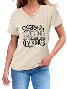 Detail of V-neck beige cotton t-shirt featuring black SORRY slogan and casual style