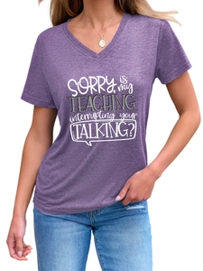 Detail of V-neck short sleeve t-shirt in purple with white Sorry Is My Teaching graphic