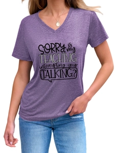 Detail of V-neck heather purple T-shirt with black SORRY is my TEACHING slogan print