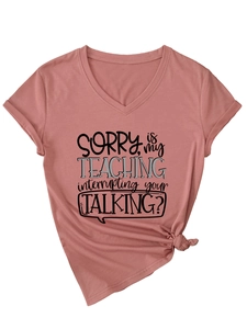 Detail view of V-neck T-shirt in mauve with SORRY IS MY TEACHING slogan and front knot