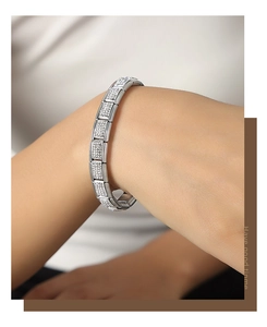 Detail of silver modular bracelet with pave-set cubic zirconia on a female wrist