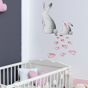 Close-up of watercolor bunny and heart wall decals in a white nursery room