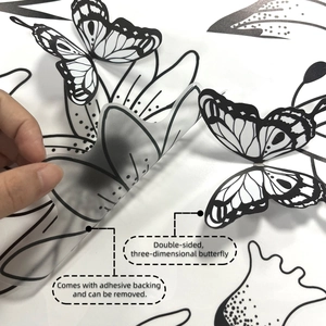 Detail of 3D black butterfly wall stickers with peel-and-stick adhesive backing