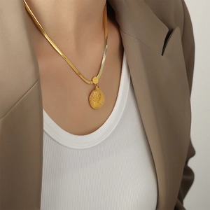 Chic 18k gold plated portrait coin pendant with sleek snake chain necklace on a model