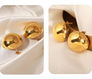 Close-up of golden polished domed earrings with mirror finish and secure butterfly backings