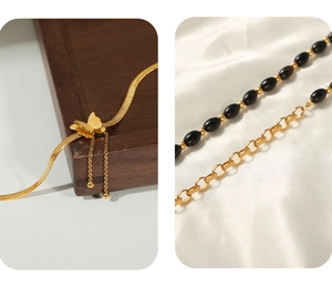 Detailed shot of gold butterfly pendant on snake chain with elegant black beaded anklet
