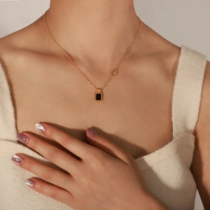 Gold-plated stainless steel necklace with black square pendant and heart detail